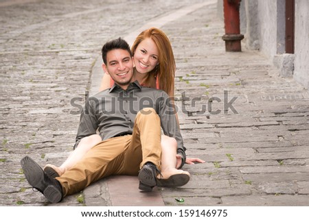 Young couple in a candid shot. They are walking in the streets of Quito, Ecuador