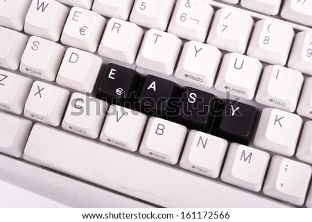 Word Easy written with black keys on computer keyboard.