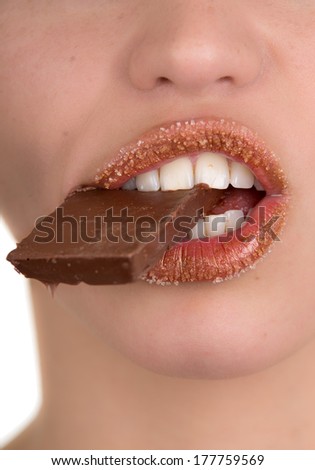 Closeup of a woman eating chocolate