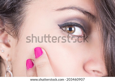girl\'s face with makeup and pink nails closeup