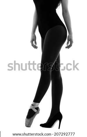 Half body shot of ballerina wearing ballet shoe and high heels shoe isolated on white in black and white