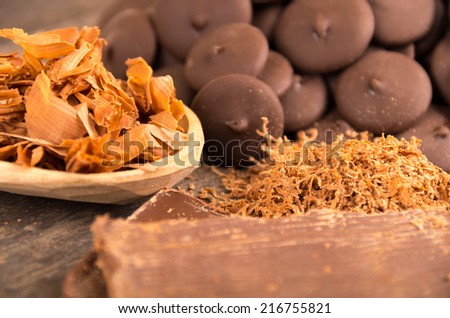 chocolate bar shredded chocolate and chocolate pieces on a wooden table selective focus