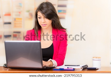 Beautiful young brunette girl student businesswoman professional working with laptop writing