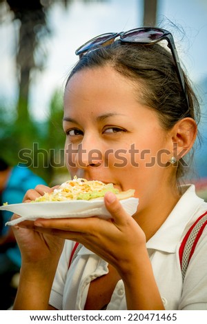 beautiful young happy girl eating a tostada soft taco pupusas in guatemala