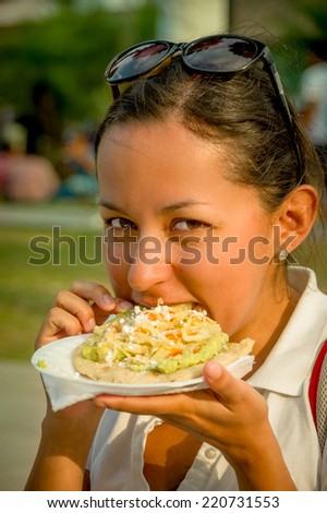 beautiful young happy girl eating a tostada soft taco in guatemala