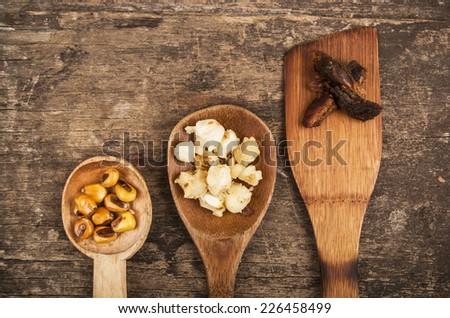 hominy and toasted corn nuts with pork skin on wooden spoons traditional ecuadorian food