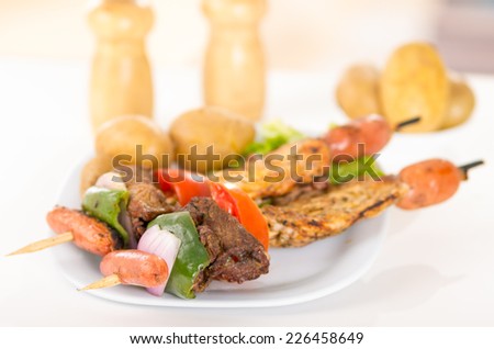 two delicious skewers shish kebab sticks grilled meat chicken on a plate closeup selective focus