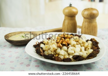 hominy and toasted corn nuts with pork skin on a plate traditional ecuadorian food selective focus