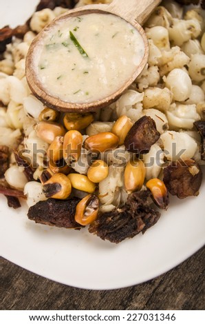 hominy and toasted corn nuts with pork skin and aji sauce  mote con chicharron traditional ecuadorian food