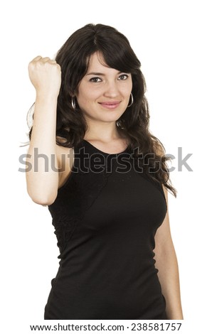 beautiful young brunette woman with black top posing holding fist up isolated on white