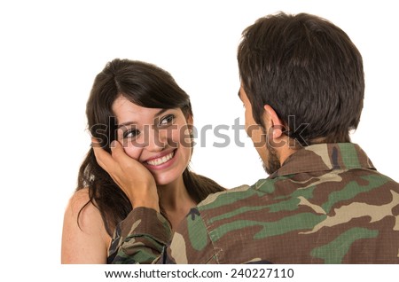 returning young military soldier caressing his wife girlfriend isolated on white