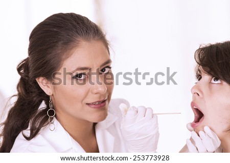 health care professional checking patient\'s throat isolated on white
