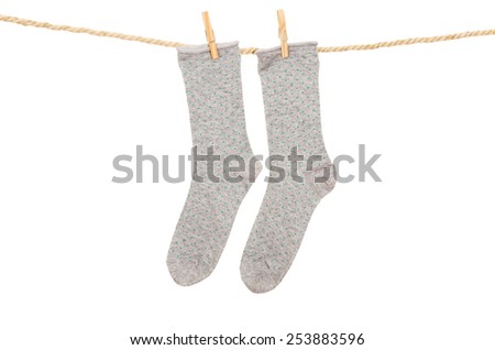socks hanging on a rope clothesline isolated on white