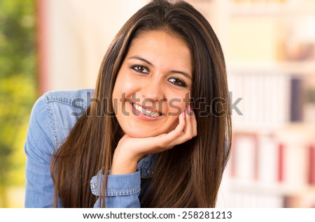 portrait of cute young brunette wearing denim shirt