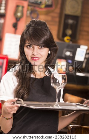 beautiful young waitress girl serving a drink holding tray