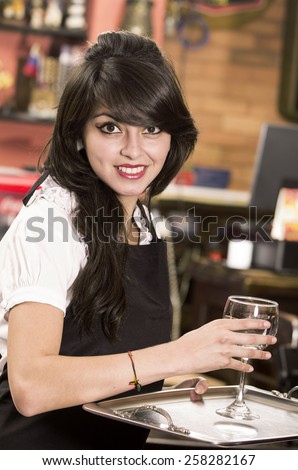 beautiful young waitress girl serving a drink holding tray