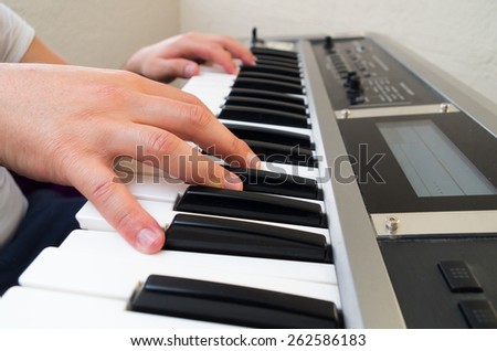 closeup photo of a musician\'s hands playing piano