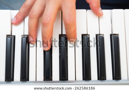 closeup photo of a musician\'s hands playing piano top view