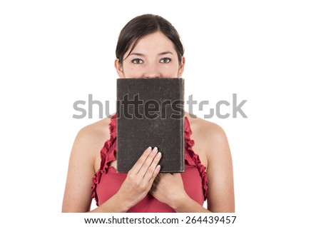 beautiful young female teacher covering face with book isolated on white