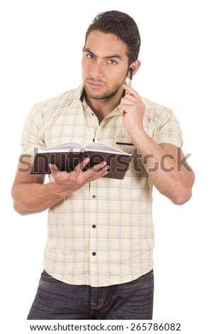 young handsome male teacher holding notebook gesturing listen with finger on ear isolated on white