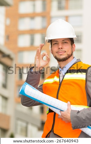 young handsome architect supervising a construction gesturing all right