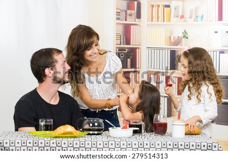 Sweet young family spending time together during breakfast