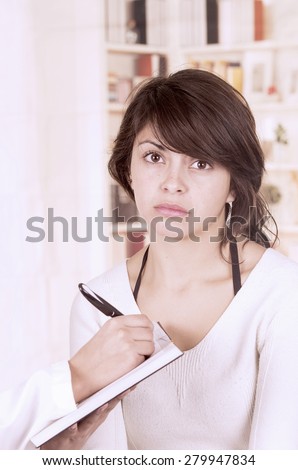 Beautiful young girl looking nervous, worried at the doctor\'s appointment