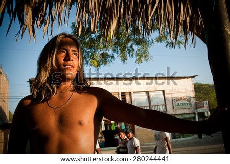 MANABI, ECUADOR - DECEMBER 18, 2011: Portrait of shirtless tanned young man from Puerto Lopez, popular vacation spot in Ecuador