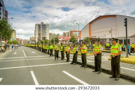 QUITO, ECUADOR - JULY 7, 2015: A long line police officers guarding the street as crowds await arrival of Pope Francis motorcade in relations to South America tour first stop Quito, Ecuador