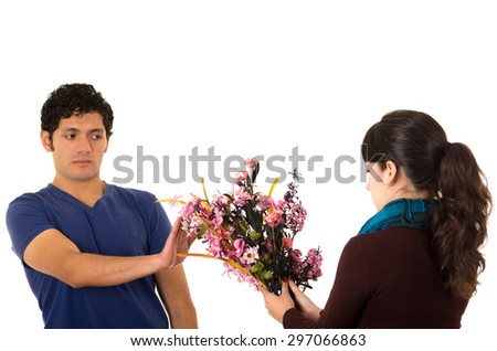 Hispanic man saying no to flowers from woman.