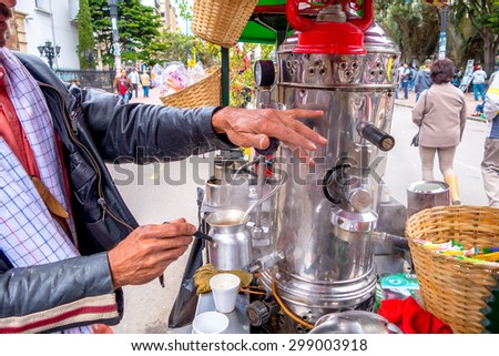 BOGOTA, COLOMBIA - FEBRUARY 25, 2015: Unidentified street vendor selling fresh coffee at Candelaria neighborhood in Bogota Colombia