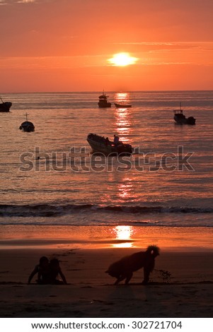 MANABI, ECUADOR - JUNE 3, 2012: Beautiful landscape view of floating fishing boats silhouette with amazing sunset in the background, Manabi, Ecuador