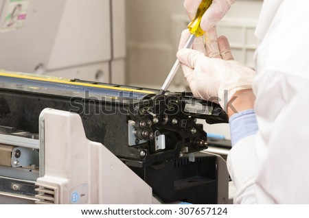 closeup shot technician fixing digital photocopier machine