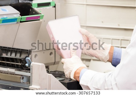 closeup shot hans changing toner cartridge in digital photocopier machine