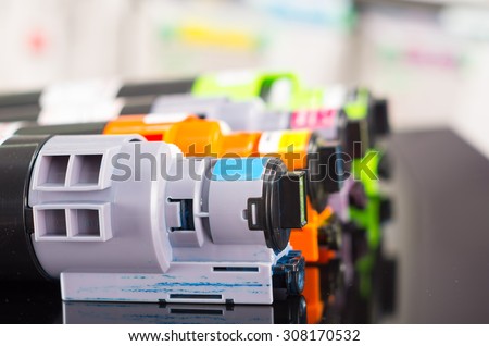 Photocopier printer cartridges cmyk closeup shot, selective focus