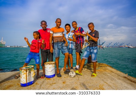 COLON, PANAMA - APRIL 15, 2015: local teens hanging by the harbor where they fish and play football in the port of Colon in Panama.