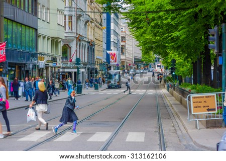 OSLO, NORWAY - 8 JULY, 2015: Daily life in busy street called Stortingsgaten, rails of tram visible .