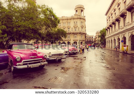HAVANA, CUBA - SEPTEMBER 4, 2015: Old classic American cars rides in front of the Capitol. Before a new law issued on October 2011, cubans could only trade cars that were on the road before 1959.
