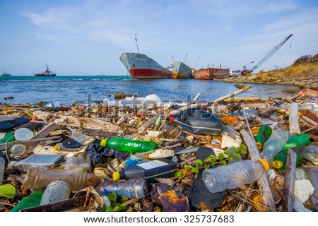 COLON, PANAMA - APRIL 15, 2015: Waste and pollution washing on the shores of the beach in city of Colon in Panama