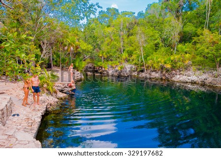 BAY OF PIGS, CUBA - SEPTEMBER 9, 2015:  Tourist attraction for swimming in Cueva de los Peces,  seaside cave with tropical fish.