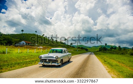 CENTRAL ROAD, CUBA - SEPTEMBER 06, 2015: American Oldtimer in the rural road system used for transportation