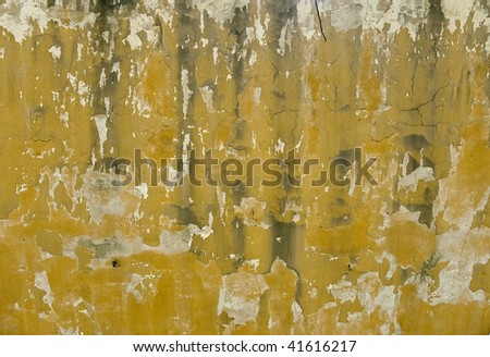 Random white, gray, black and yellow grunge background with multiple layers, stains and cracks.