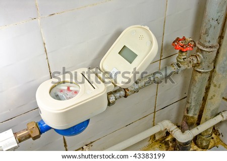 Old rusty colorful red brass valve and blue water-meter with rusty  tubes on white background.