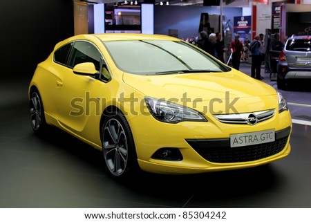 FRANKFURT AM MAIN, GERMANY - SEPTEMBER 19: A yellow Opel (Vauxhall) Astra GTC car is presented at the IAA International Motor Show on September 19, 2011 in Frankfurt, Germany. This is the world debut of this vehicle.