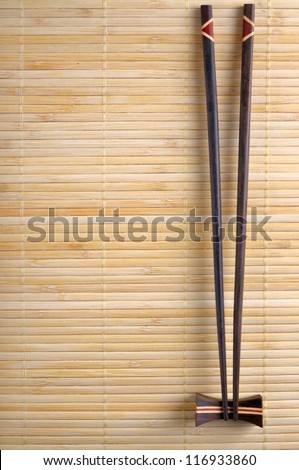 Two chopsticks on sushi mat