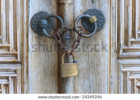 Old iron security lock of ornamental wooden door