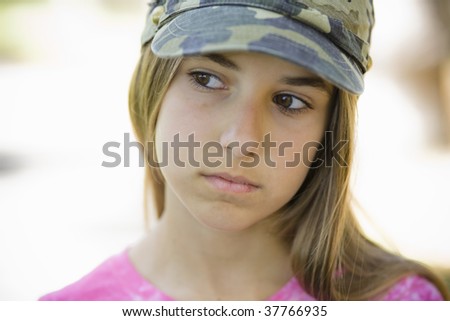 Portrait of Tween Girl in Cap Looking away from Camera