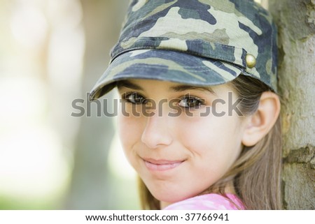 Portrait of Smiling Tween Girl Leaning Against Tree
