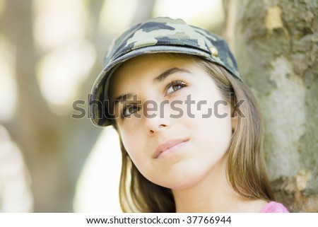 Portrait of Tween Girl in Cap Looking Up To Sky