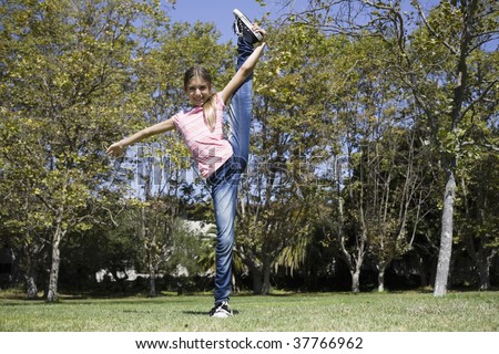 Portrait of Tween Girl Doing Gymnastics on Lawn